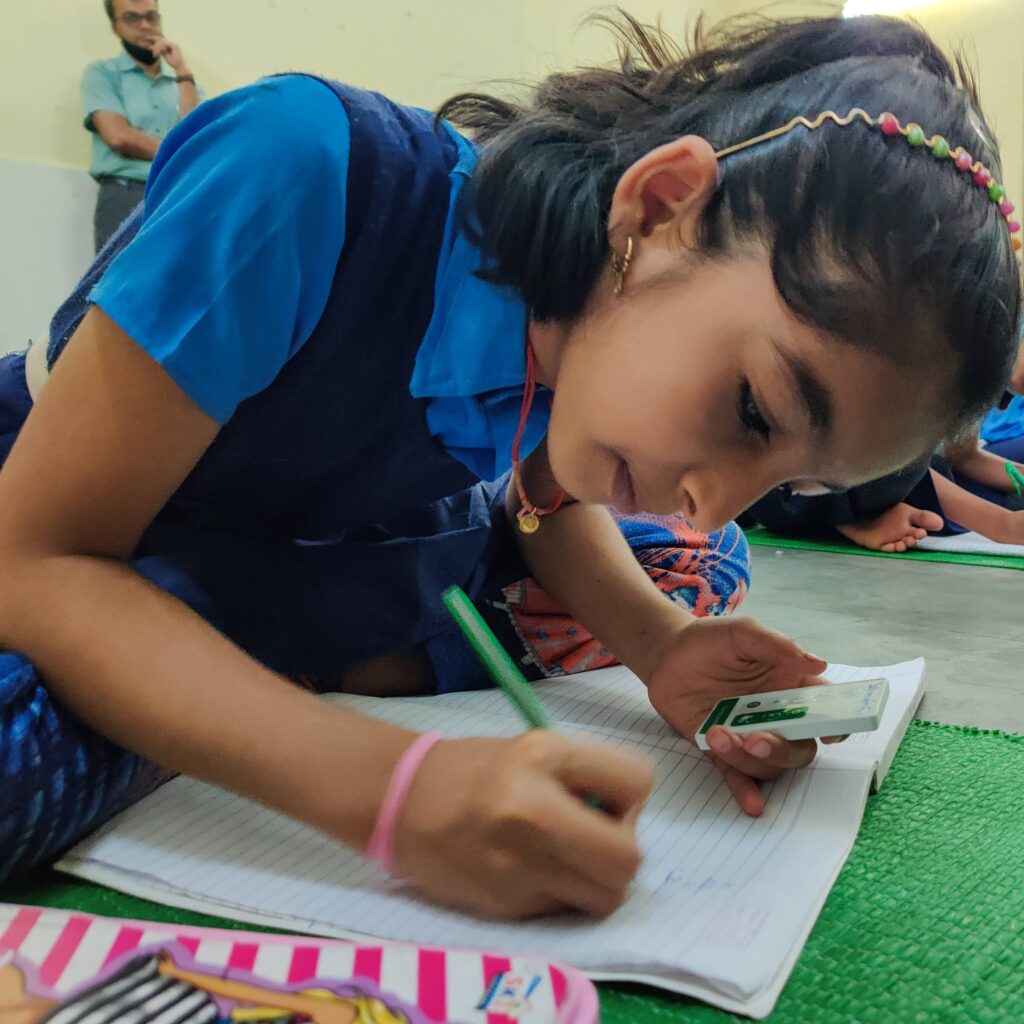 School girl using Class Saathi Bluetooth clicker in classroom for formative assessment