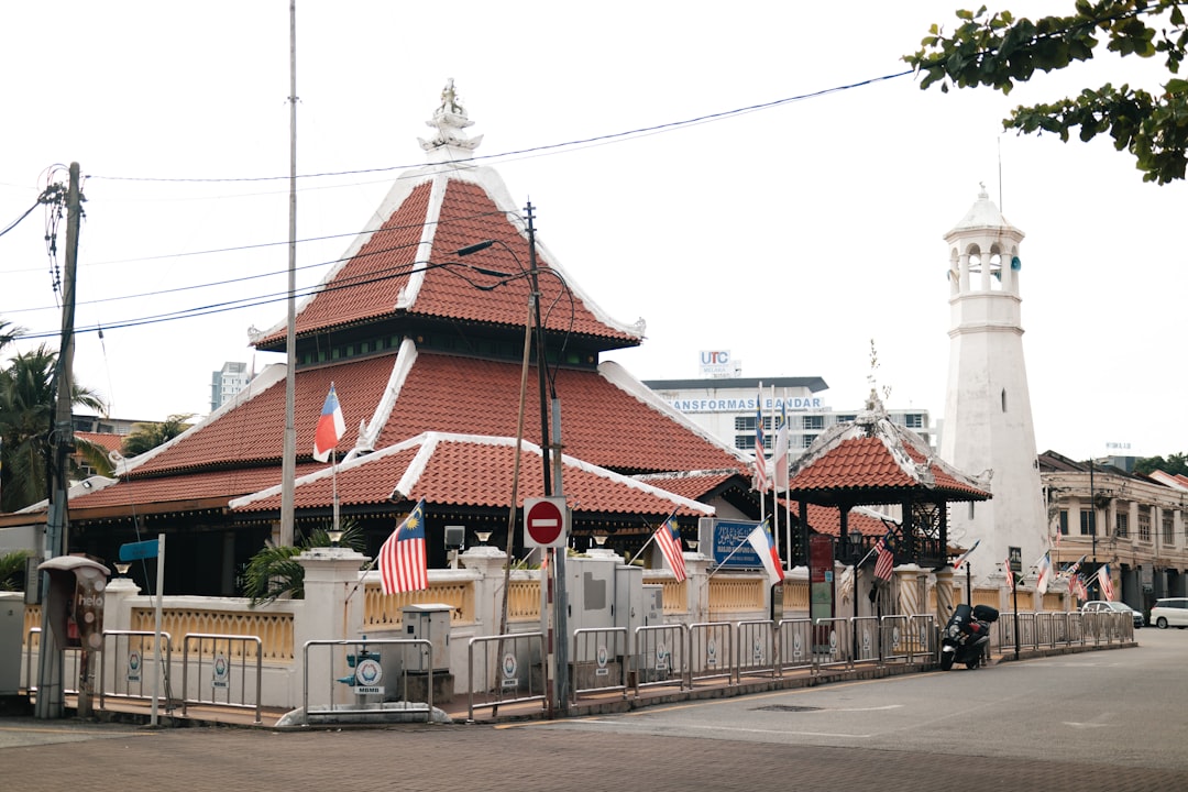 a red and white building with a clock tower in the background