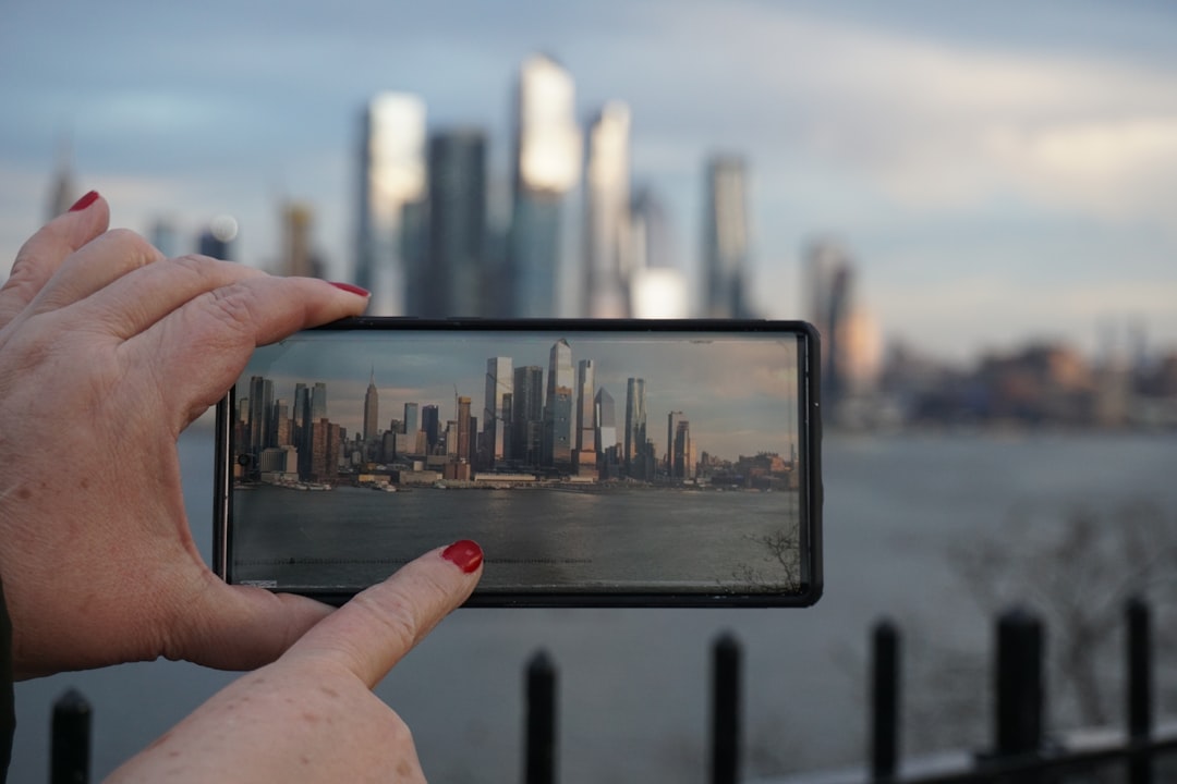 A person taking a picture with a cell phone