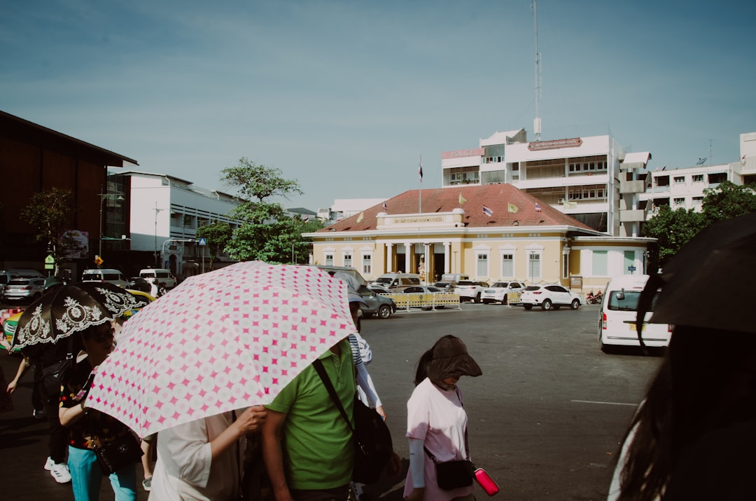 a group of people walking down a street holding umbrellas