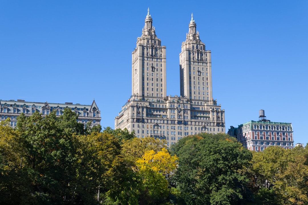 a group of buildings with trees in front of them